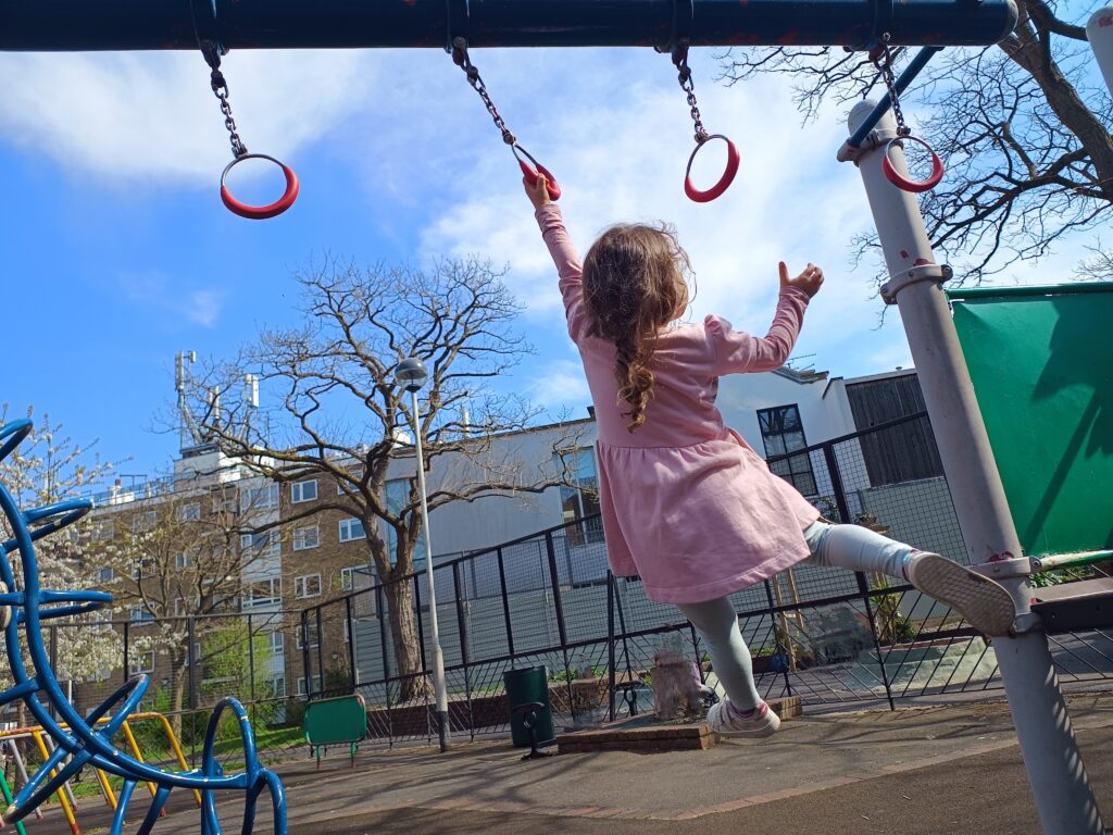 Child on monkey bars